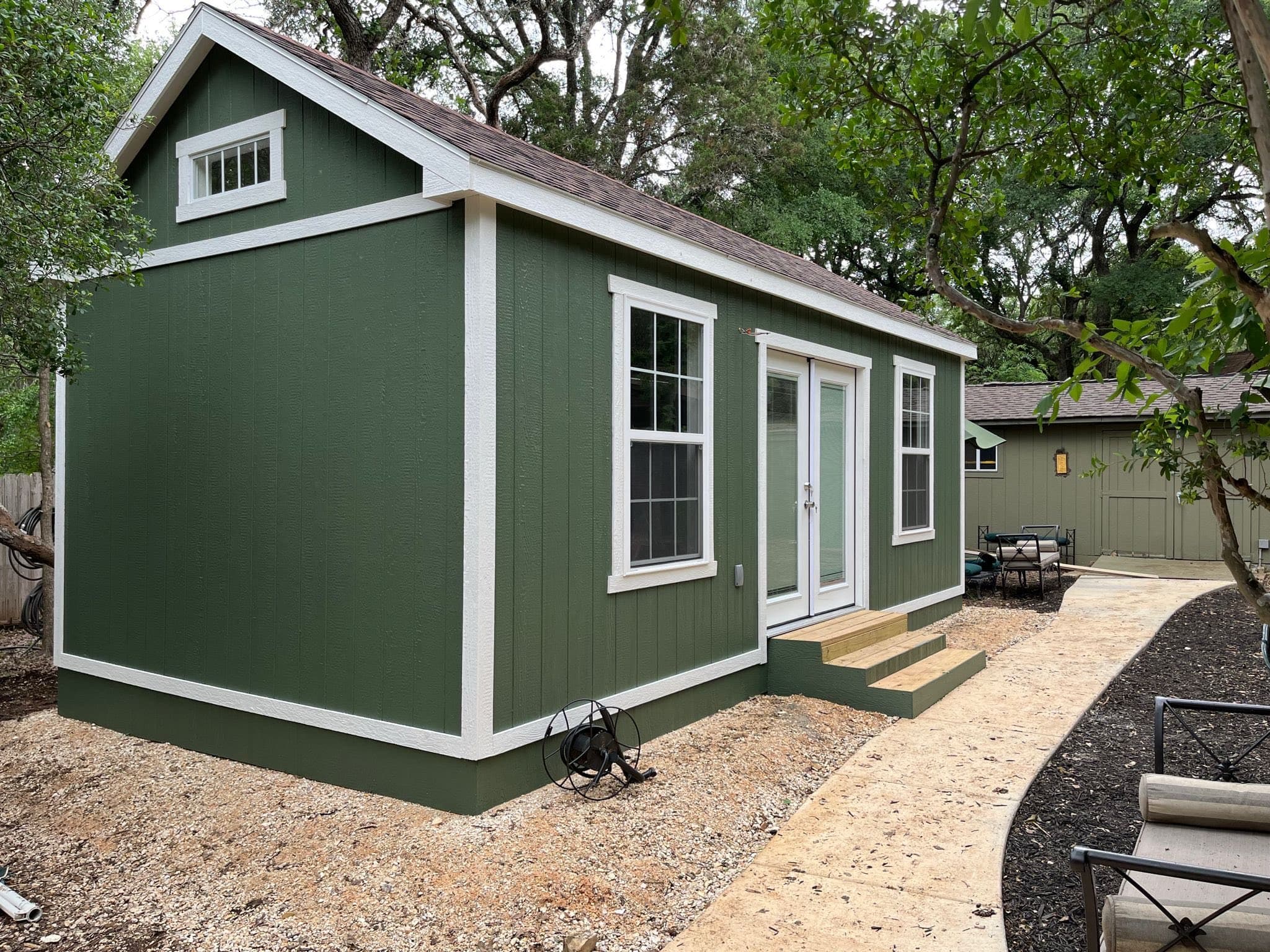 Garden office shed with large windows and wooden deck
